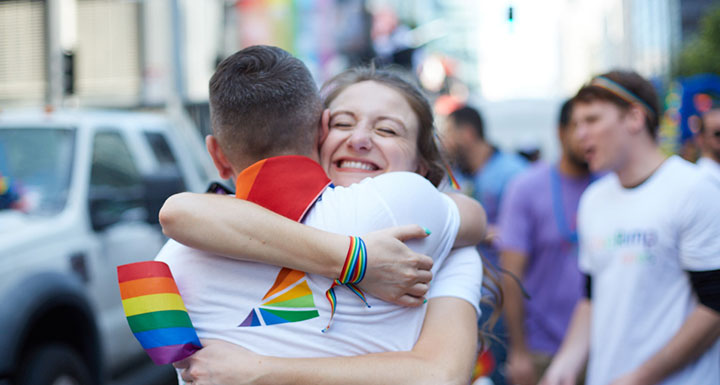 Two team mates hugging at Pride